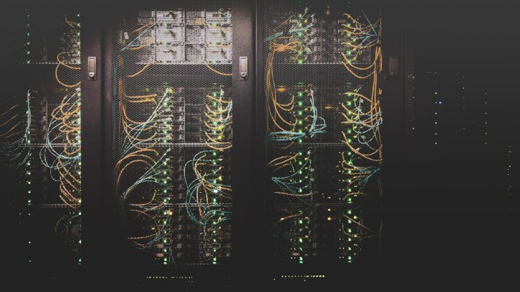 Server racks with network cables and green indicator lights in a data centre